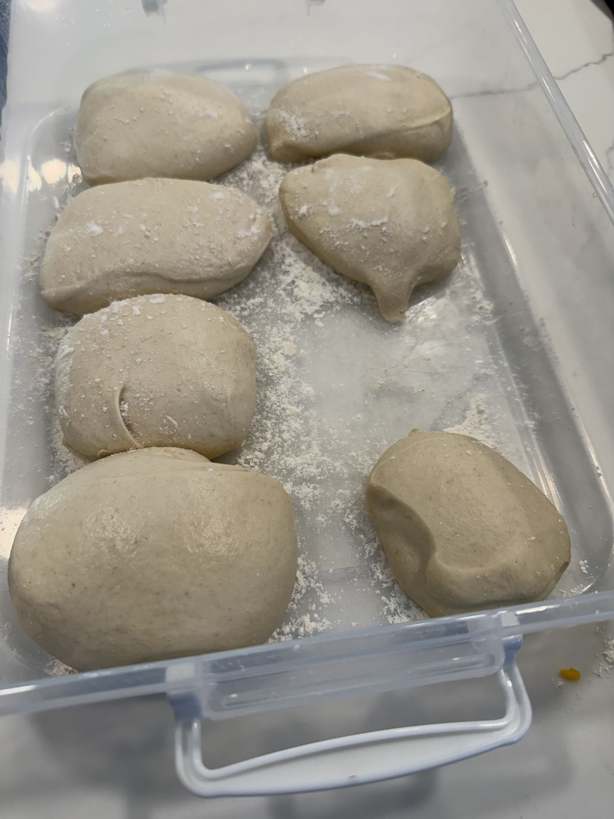 Six balls of Caputo 00 pizza dough in a floured proofing tray, ready for the fridge