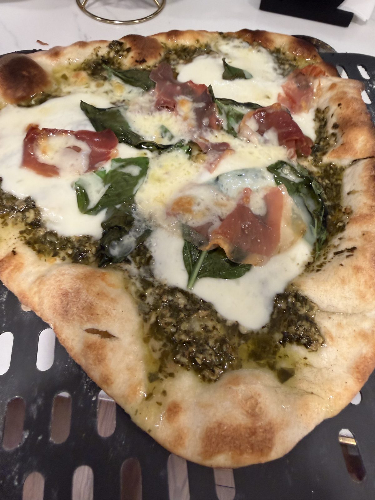 Pesto pizza baking in the Ninja Woodfire oven